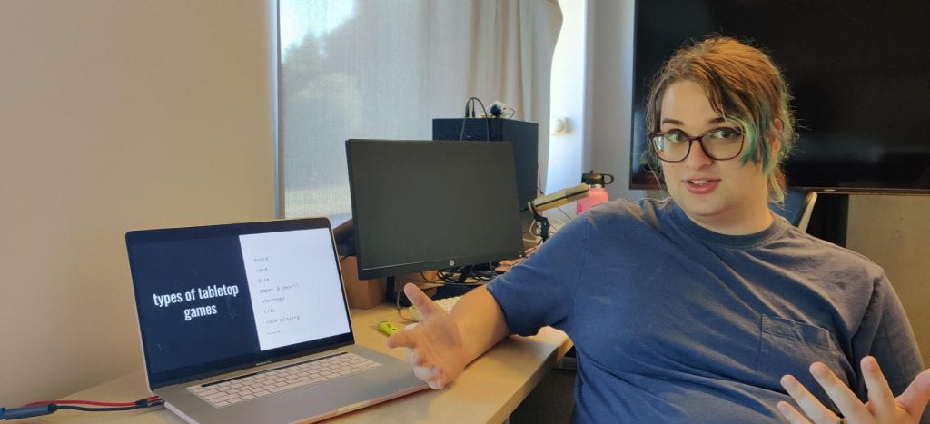 dani wright in front of a laptop that reads: types of tabletop games